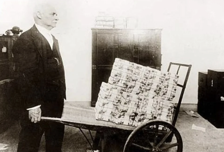 People carrying stacks of cash